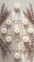 Autumn flat lay with white pumpkins, clear quartz crystals and dried eucalyptus branches arranged on neutral linen background for seasonal decor.