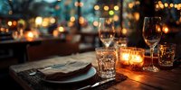 Elegant table setting with wine glasses and candlelight at dusk, creating romantic ambiance for fine dining experience in upscale restaurant.