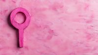 Pink female gender symbol on textured pink background with brush strokes and copy space, representing femininity, women's rights and empowerment.