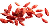 Dried red goji berries scattered on white background, superfood ingredient for healthy eating and natural medicine.
