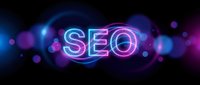 Glowing neon SEO text with colorful bokeh lights on dark background for digital marketing and search engine optimization concepts.