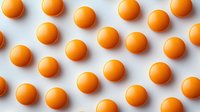 Orange spheres arranged in rows on white background creating geometric pattern for modern design projects and creative layouts.