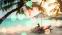 Blurred tropical beach scene with palm trees and colorful bokeh lights creating dreamy vacation atmosphere for summer travel backgrounds and relaxation concepts.