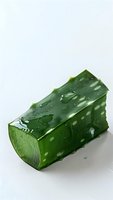 Fresh cut aloe vera leaf segment with water drops on green gel surface, isolated on white background for skincare and cosmetic product photography.