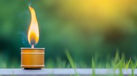 Small candle flame burning brightly on wooden surface with soft green natural background blur for meditation and relaxation concepts.