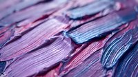 Closeup of textured paint strokes in vibrant purple, pink, and blue hues creating an abstract artistic composition for creative design projects.