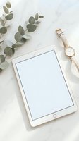 White tablet with blank screen on marble surface with eucalyptus leaves and gold watch for modern workspace mockup and digital lifestyle branding.