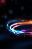Glowing spiral light trail with blue, orange and purple colors against dark background, sparkling particles and bokeh effects create magical atmosphere.