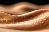 Abstract macro photography of glittering sand dunes with golden particles creating smooth waves and curves against dark background, artistic desert landscape concept.