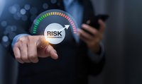 Businessman touching a glowing risk management gauge with arrow pointing high, holding smartphone, dark background, business strategy concept.