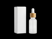 Frosted glass dropper bottle with bamboo cap and white packaging box, isolated on transparent background. Ready for cosmetics, skincare, essential oils, serums, and wellness product design use.