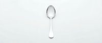 Single silver spoon isolated on white background for kitchen design and culinary projects.