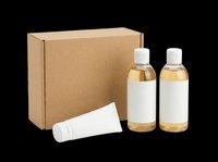 Cosmetic set with two bottles and a tube next to a kraft box, isolated on transparent background, ready for T-shirt, sticker, and print on demand design use.