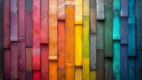 Colorful wooden planks arranged in vertical pattern creating rainbow gradient from pink to blue, textured surface with rustic weathered finish. Abstract architectural detail.