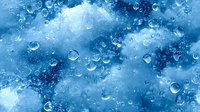 Transparent water drops on blue cloudy background create dreamy atmosphere. Falling raindrops and bokeh effects form magical pattern for nature designs.