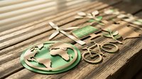 Paper cut green eco icons on wooden surface featuring globe, wind turbine, solar panel, bicycle and plant symbolizing sustainable energy concept.