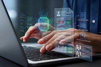 Businessman using laptop with holographic digital interface displaying data analytics, artificial intelligence and futuristic technology concepts.