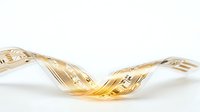 Twisted golden glass ribbon isolated on white background, suitable for modern design projects, web graphics, and decorative applications.