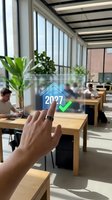 Augmented reality interface showing 2027 house icon with checkmark on transparent glass panel in modern office workspace with employees and natural light.