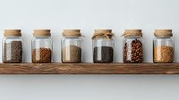 Assorted dried legumes and grains in glass storage jars with cork lids arranged on wooden shelf, minimalist pantry organization for sustainable kitchen lifestyle.