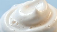 Creamy white moisturizer swirl with smooth texture and bubbles for skincare cosmetics beauty products packaging design and advertising materials.