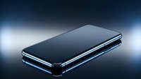 Sleek smartphone with black screen and metallic frame displayed against soft blue lighting and reflective surface for tech product showcase.