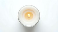 Burning white candle in glass jar, top view, isolated on white background. Soft warm flame for spa, wellness, and home decor concepts.