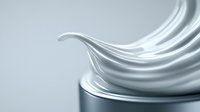 Luxurious white cream swirl texture with smooth flowing curves against light background, showcasing cosmetic product consistency and moisturizing properties.