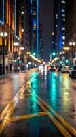 Blurred city street at night with wet pavement reflecting colorful lights from buildings and traffic in urban downtown area during evening hours.