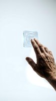 Senior hand touching futuristic holographic interface button on white background for technology and innovation concepts.