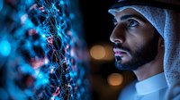 Middle Eastern man in traditional white kandura and headscarf gazes at glowing blue and red network visualization, dramatic side lighting creates modern technological atmosphere.