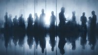 Business professionals silhouettes standing in modern office with city skyline view and reflective floor creating dramatic corporate atmosphere.