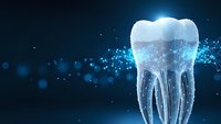 Digital tooth model with glowing particles and network connections on dark blue background for dental technology and healthcare innovation concepts.
