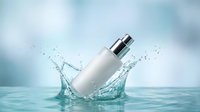 White cosmetic bottle with silver pump dispenser splashing into clear water creating dynamic splash effect against soft blue background for skincare advertising.