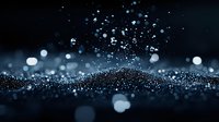 Magical glowing blue particles and bokeh lights scattered on dark background create atmospheric mood with shallow depth of field and dreamy sparkle effect.