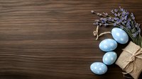 Blue Easter eggs with lavender bouquet on rustic wooden background with copy space for holiday greeting cards.