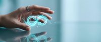 Hands holding glowing infinity symbol representing endless possibilities, sustainability, and circular economy concepts for business and technology applications.