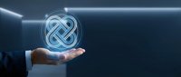 Businessman hand holding glowing infinity knot symbol representing endless possibilities, continuous growth, and sustainable business solutions for corporate branding.