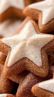 Star-shaped cinnamon sugar cookies dusted with powdered sugar in macro view, showing detailed texture and sparkly sugar coating for festive holiday baking.