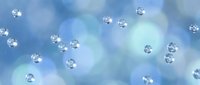 Sparkling diamonds floating against soft blue gradient background with ethereal glow effects for luxury jewelry advertising and premium brand marketing.