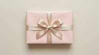 Pink gift box with elegant satin ribbon bow on neutral background for special occasions and celebrations.
