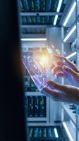 Hands of a technician interacting with holographic digital interface displaying concentric circles and data icons in modern server room with neon lighting and server racks.