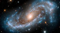 Majestic spiral galaxy with glowing blue arms and bright central core surrounded by countless stars in deep space, captured in stunning astronomical detail.