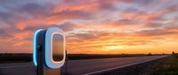 Futuristic electric vehicle charging station glowing at sunset on rural highway, sustainable energy infrastructure for eco-friendly transportation and clean power solutions.