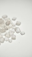 Raw rough diamonds and gemstones scattered on white background, isolated crystals ready for jewelry design, luxury mineral specimens for commercial use.