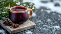 Steaming mulled wine in wooden cup with star anise on rustic board. Winter holiday drink with cranberries and spices against snowy bokeh background.