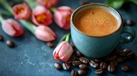 Aromatic espresso in turquoise ceramic cup with fresh pink tulips and scattered coffee beans on dark textured background, romantic morning concept.