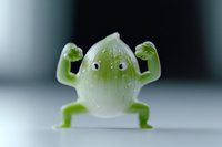 Playful green lime character with googly eyes and muscular arms flexing in superhero pose on white background, isolated food art concept for healthy eating promotion.