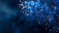 Vibrant blue fireworks exploding against dark night sky, creating magical sparkling light display for celebration events.