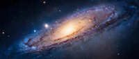 Spiral galaxy with glowing core and cosmic dust lanes against starfield background for astronomy and space science educational materials.